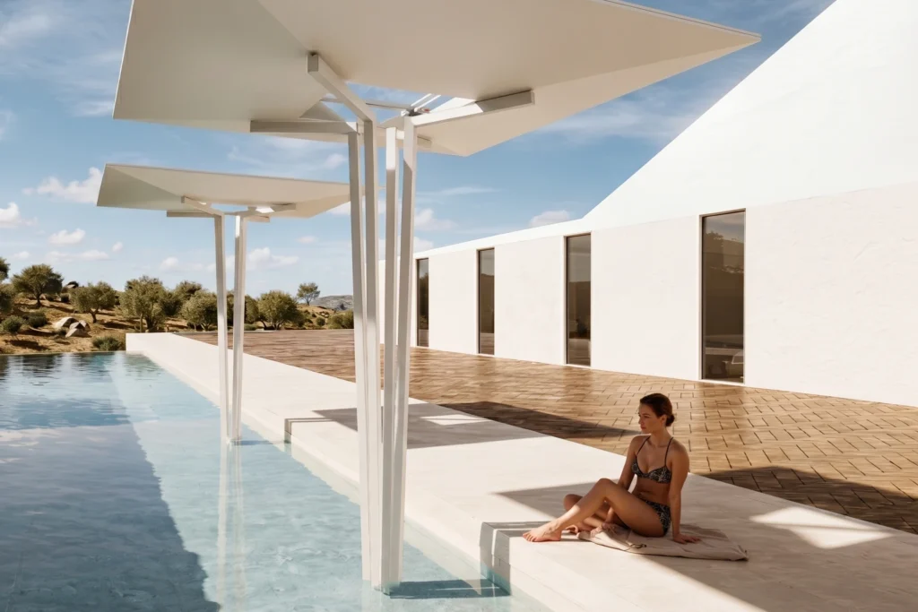 Poolside deck beside a white modern building, guest lounging in the sun