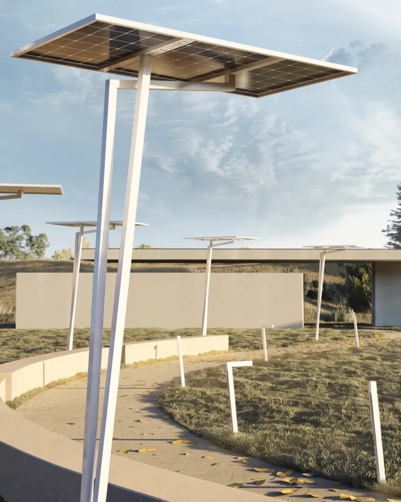 Solar panels mounted on tall white poles along a paved walkway in a landscaped area under a blue sky.