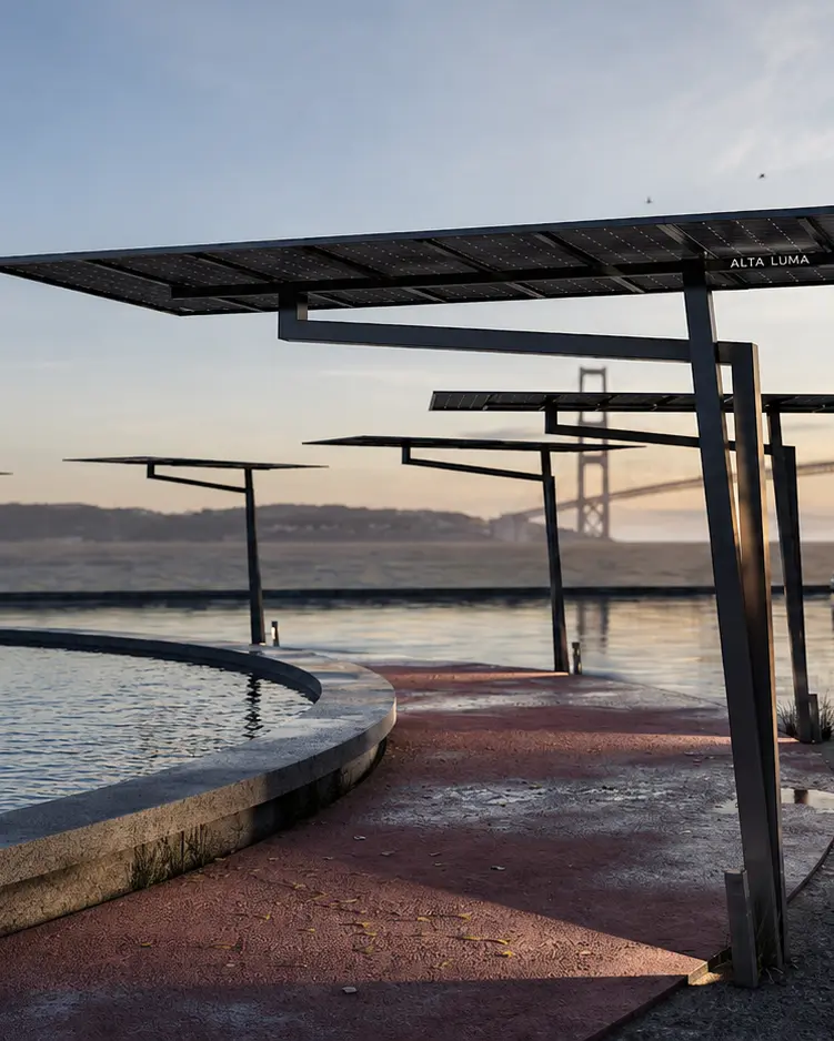 Waterfront promenade with metal solar-panel canopies over a curved pool and a distant bridge at dusk, calm water reflecting the lights.